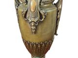 an image of a bronze vase on a marble base