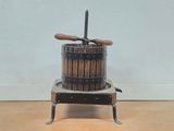 a small wooden machine that is sitting on a wooden floor
