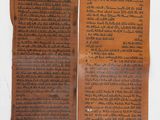deux morceaux de papier kraft sur lesquels sont écrits des mots, posés sur une table
