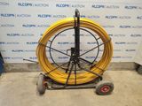 an image of a large yellow hose on a cart
