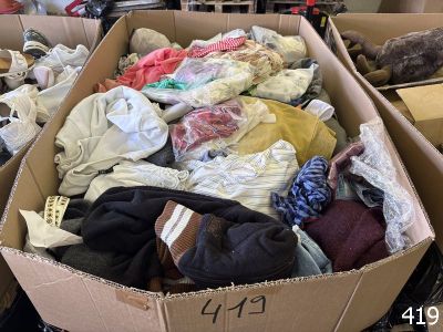 a cardboard box filled with clothes and other items