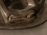 a bronze statue of a man holding a cat