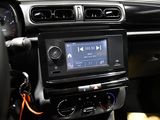 a car dashboard with a radio and a steering wheel