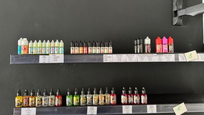 many bottles of liquid on the shelves in the store