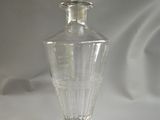 a clear glass bottle with a silver lid