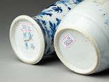 pair of blue and white vases sitting on top of a table