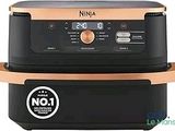 two black and copper air fryers sitting on top of each other