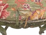 a green bench with a floral design on it
