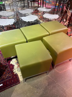 a lot of different colored stools and chairs in a store