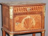 a small wooden cabinet with a drawer on top of it