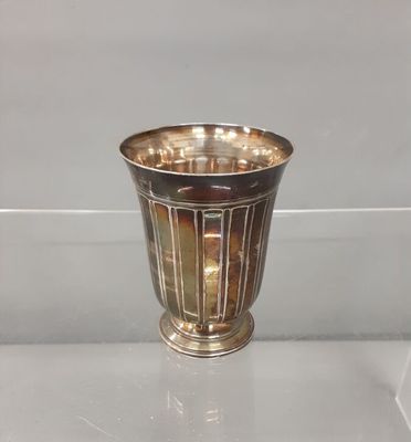 a silver vase that is sitting on a table