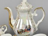a tea set with a teapot, cups, and saucers