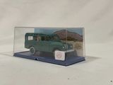 an image of a green toy car in a clear display case