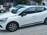 a small white car parked on the side of the road