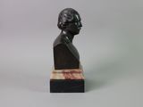 a close up of a bust of a man on a marble base