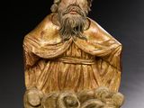 une image représentant la statue d'un homme barbu assis sur un rocher