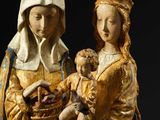 an image of a statue of a woman holding a baby and a basket of fruit