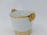porcelain cup with gold decoration on the handle