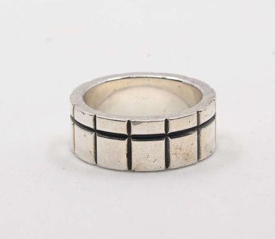 a close up of a silver ring on a white surface