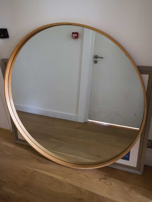 a mirror that is sitting on the floor in front of a mirror