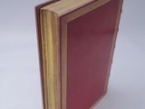 a red book sitting on top of a white table