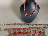 a necklace, bracelet, and bracelet set on a table