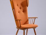 une chaise orange avec une structure en bois et des accoudoirs, sur fond blanc