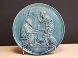a blue plate with a picture of a man and a woman sitting at a table