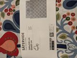 a white envelope with a pattern on it sitting on a bed