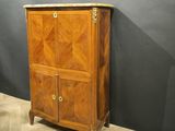 a wooden cabinet with two doors and a marble top