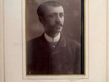 portrait of a man in a suit and bow tie in a picture frame