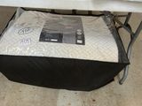 a mattress that is sitting under a folding table
