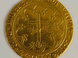 an image of a gold coin with a cross on it