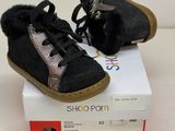 pair of black and silver baby shoes sitting on top of a box