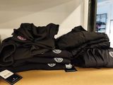 a lot of t - shirts on a shelf in a store