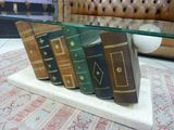 a glass table with books on it and a couch in the background