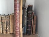 many books on a shelf next to a chair