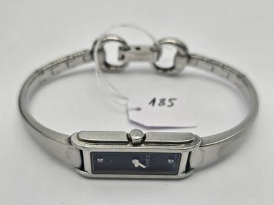an image of a silver bracelet with a black dial on it