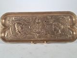 an antique brass tray with a design on it