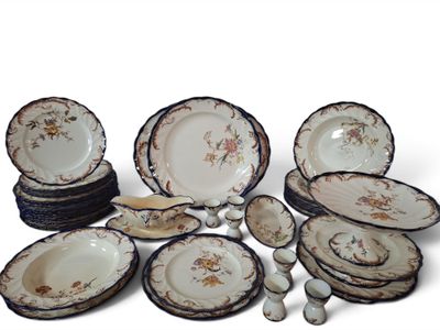 a lot of plates and bowls that are sitting on a table