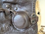 a close up of a brown leather bag with a metal latch