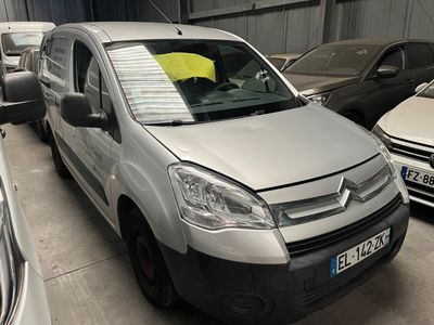 a silver van parked in a parking lot with other cars
