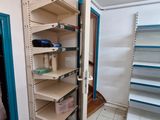 a large open shelf in the corner of a room