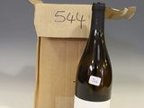 a bottle of wine that is sitting next to a box