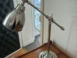a lamp that is sitting on a table in front of a clock