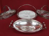 four silver trays on a red table with a red background