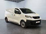 the white van is parked in the large room of the building