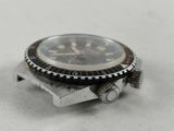 a watch that is sitting on top of a piece of metal