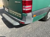 a green van that is parked on the side of the road