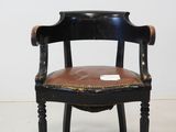 an image of a black chair with a brown leather seat